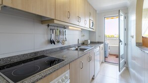 A modern kitchen with granite countertops, stainless steel appliances, and wooden cabinets.