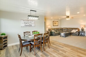 A dining area with a table and chairs, a ceiling fan, and a sign on the wall. - Ranch Escape w/ Patio ~ 21 Mi to Bryce Canyon (Panguitch)