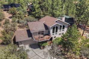 A two-story house with a balcony, a garage, and a driveway.