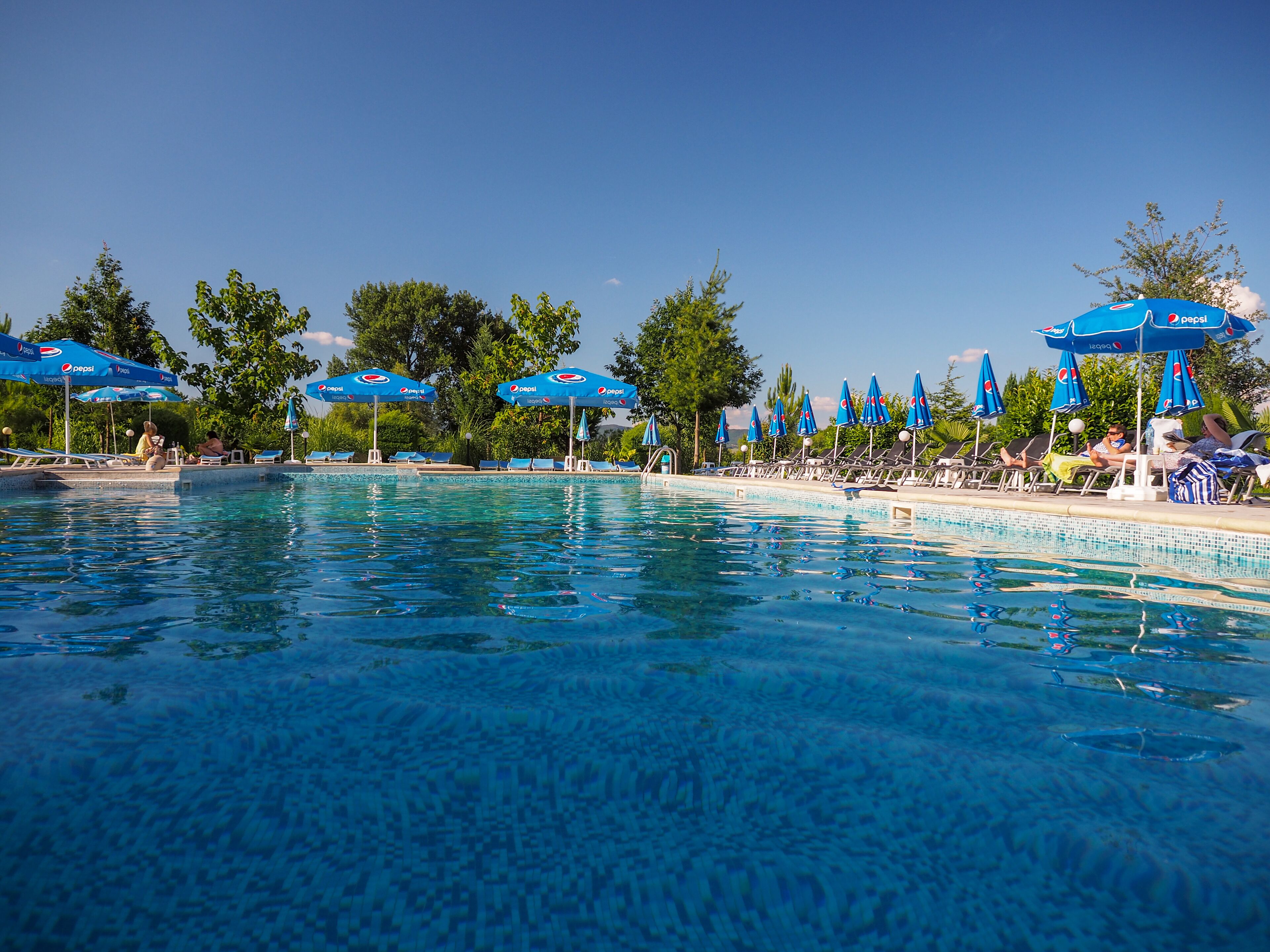 Outdoor pool, open 6:00 AM to midnight, pool umbrellas, sun loungers