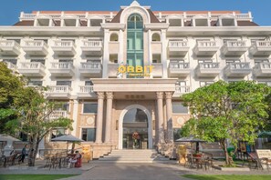 A hotel with a grand entrance, multiple balconies, and outdoor seating areas. - Orbit Hotel Nha Trang (Nam Nha Trang)