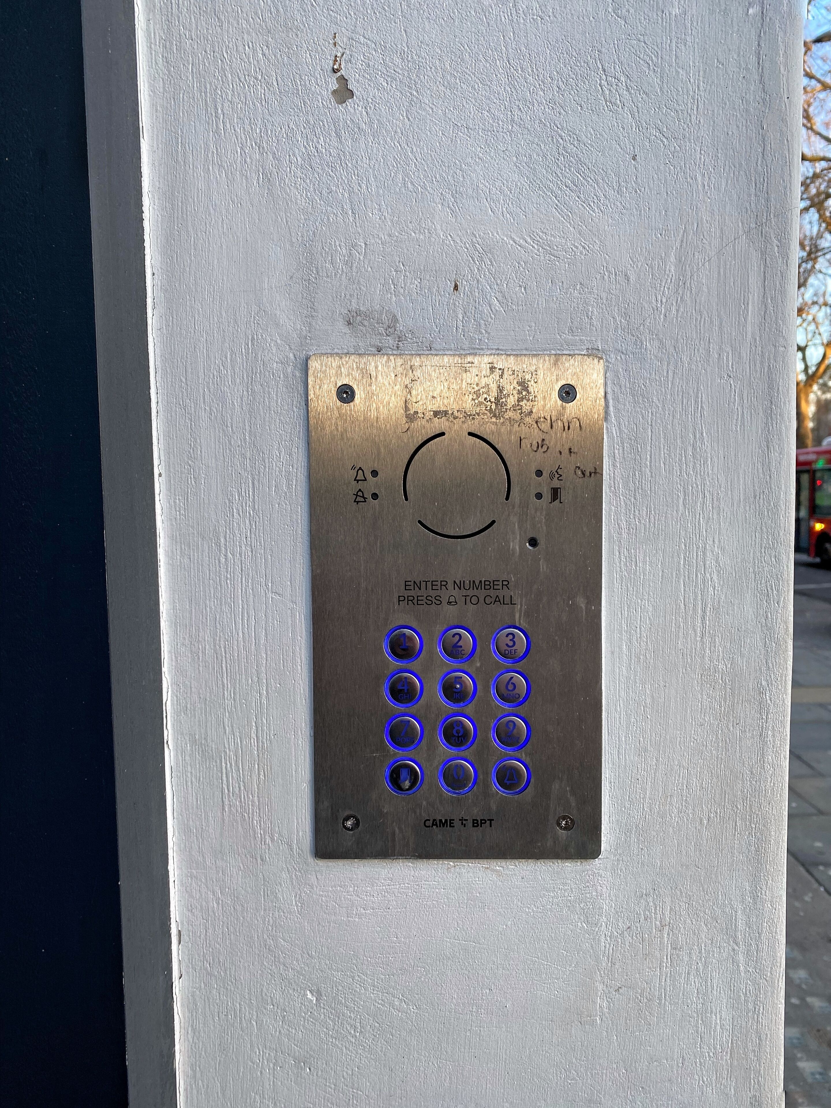 A keypad with instructions to enter a number and press a button to call.