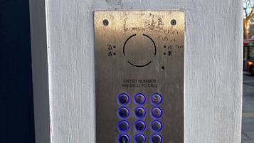 A keypad with instructions to enter a number and press a button to call.