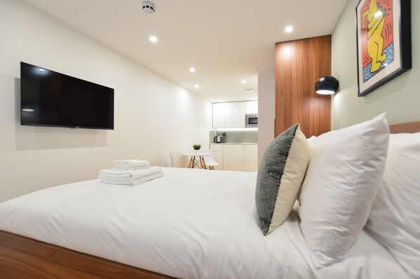 Small Lower Ground Floor | Living area | 24-inch flat-screen TV with satellite channels, TV, heated floors - Shepherds Bush Green Serviced Apartments by Concept Apartments (London)
