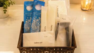 A tray with a ladies set including a toothbrush, hair brush, razor, and sponge.