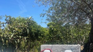 An electric vehicle charging station with a white car parked nearby, set against a backdrop of trees and a clear sky. - BON Repos Apartment With Swimming Pool (Alghero)
