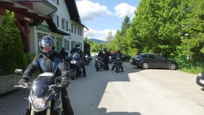 A group of motorcyclists parked in front of a building with a sign that reads "PENSION". - Smartmotel (Straß im Attergau)