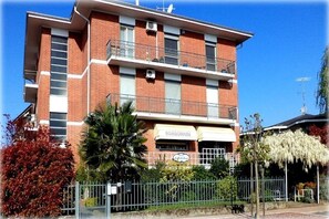A multi-story building with a sign reading 'BOMBONIERE' indicating a restaurant or dining establishment. - WATER -  WHOLE APARTMENT 4 GUESTS (Biandrate)