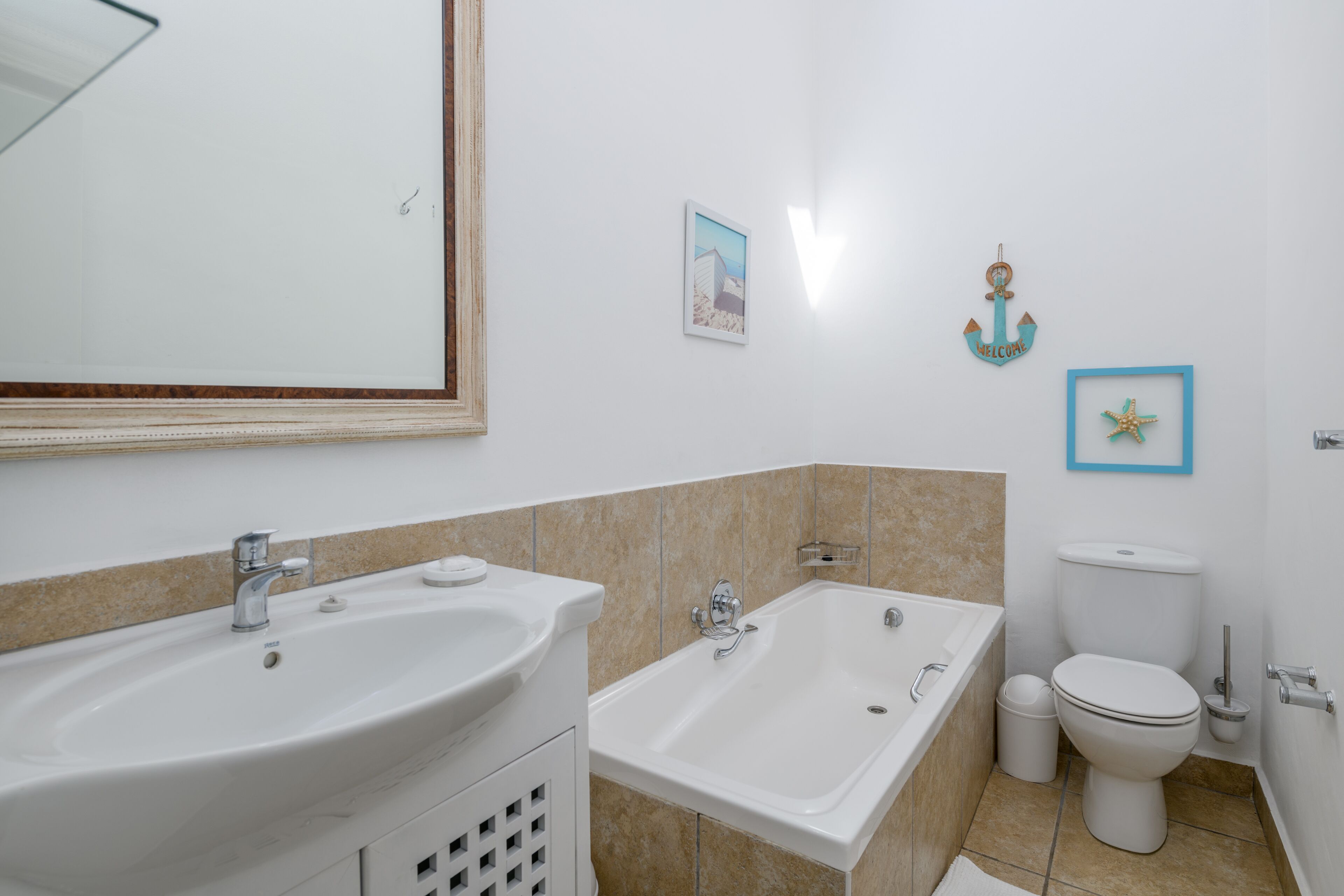 A bathroom with a sink, bathtub, and toilet.