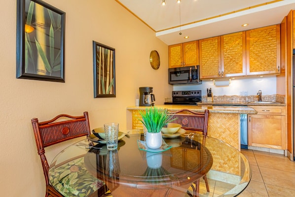 A modern kitchen with wooden cabinets, a microwave, and a coffee maker.