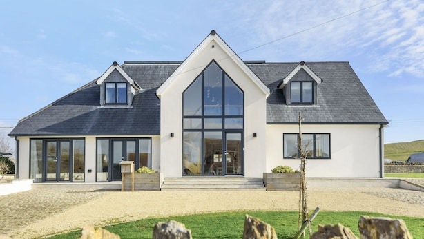 A modern two-story house with a large central glass door, a sloped roof, and a gravel driveway. - All Views, Burton Bradstock, Bridport (Bridport)