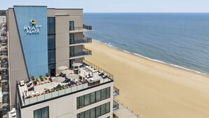 A high-rise building with a visible "Hyatt Place" sign, a rooftop terrace with outdoor seating, and a beach view. - Hyatt Place Virginia Beach / Oceanfront (Virginia Beach)