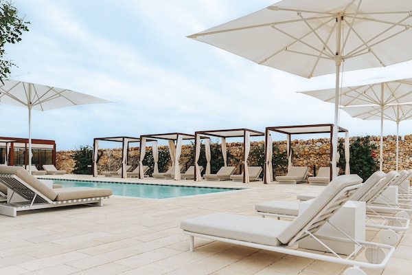 Een seizoensgebonden buitenzwembad en parasols bij het zwembad