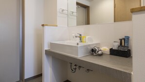 A modern bathroom with a white sink, mirror, and towel rack. - Mr.KINJO in Miegusuku (Naha)