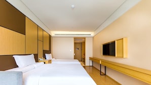A hotel room with two beds, a TV, a desk, and a bathroom visible in the background. - Ji Hotel (xi'an Giant Wild Goose Pagoda East Xiaoz (Xi'an)