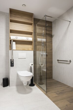 A modern bathroom with a glass-enclosed shower, a wooden vanity, and a white sink. - Hotel Beskid Balneo Medical Resort & SPA (Piwniczna-Zdroj)