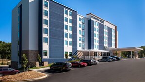 A modern hotel with a large parking lot and a covered entrance. - SpringHill Suites Chester (Chester)