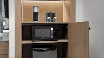Una cocina compacta equipada con microondas, cafetera y lavavajillas.