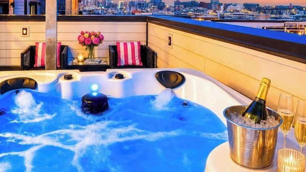A rooftop terrace with a hot tub, champagne, and towels. - Rooftop deck, hot tub & neon game room | Nashville, sleeps 12 (Nashville)