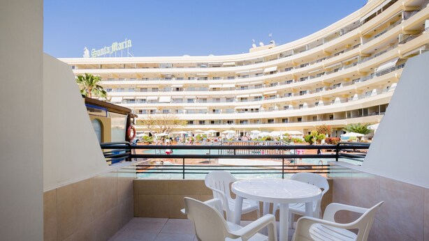 A hotel with multiple balconies, a pool area, and outdoor seating. - Great location!1 bedroom Costa adeje very central (Costa Adeje)
