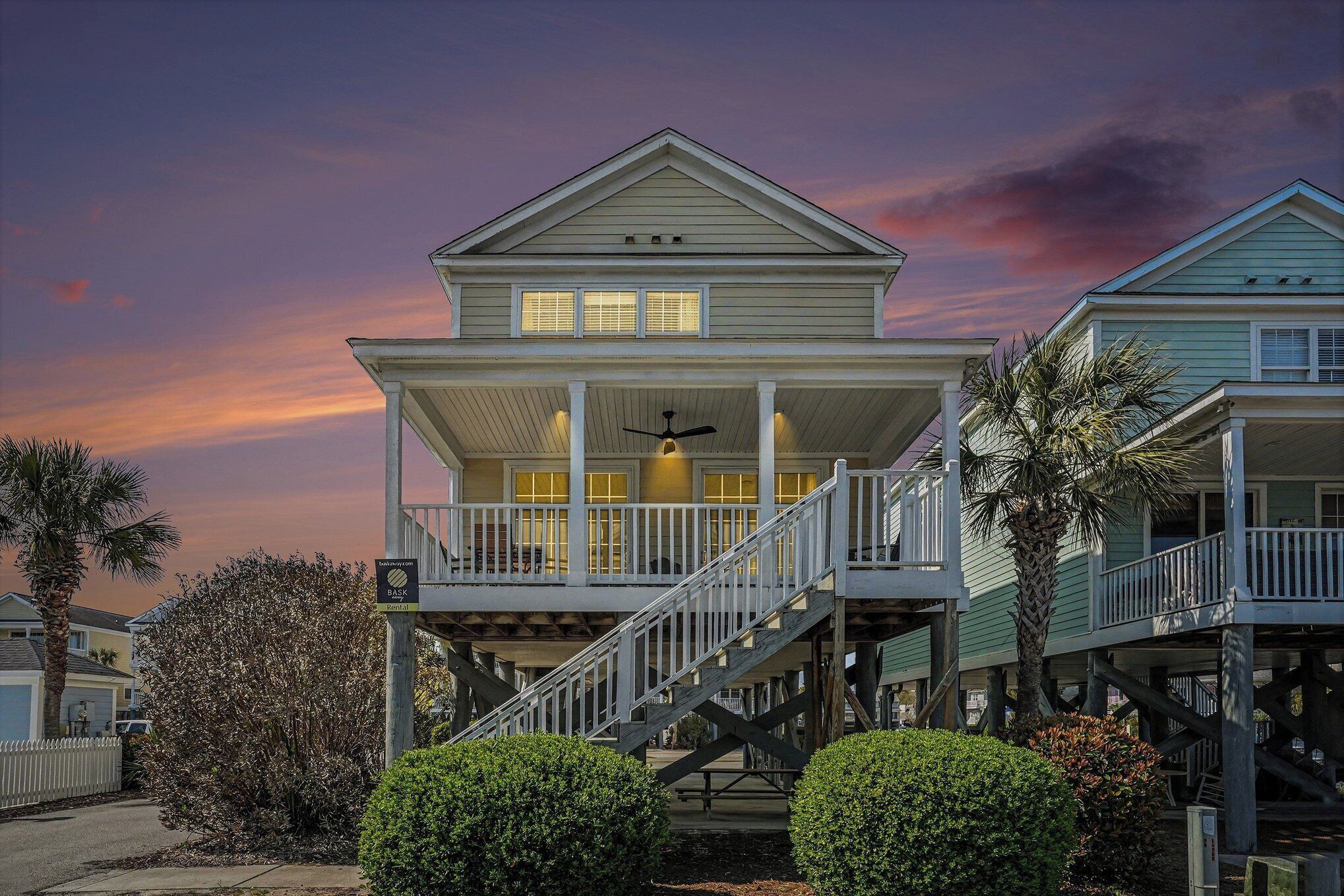 A two-story house with a balcony, a staircase, and a porch.