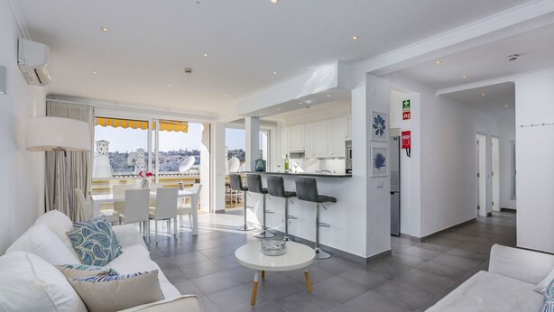 A modern apartment with a living room, dining area, kitchen, and balcony. - Clube do Monaco Stunning Beachfront Apartment Overlooking Town (Albufeira)