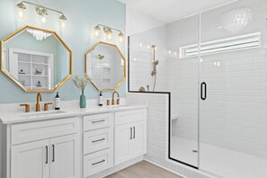 Bathtub, hair dryer, towels, shampoo