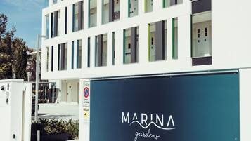A modern building with a sign that reads "MARINA gardens".