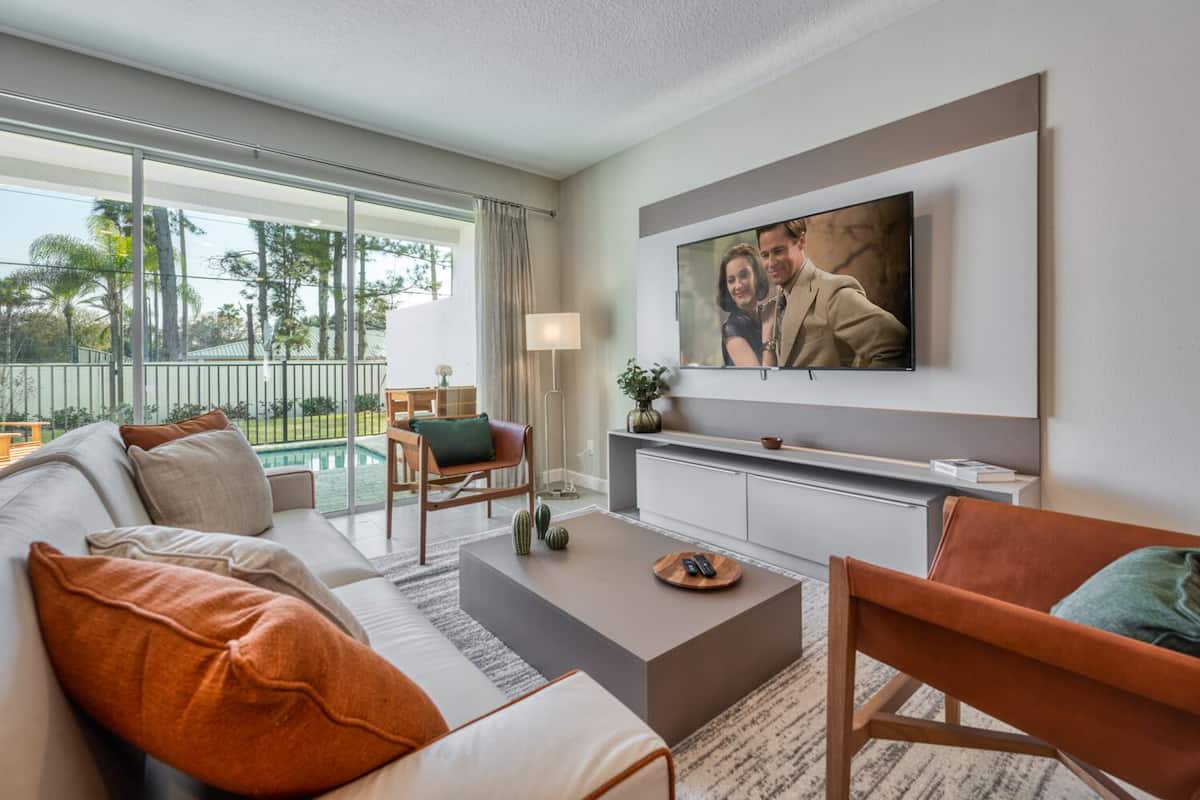 A modern living room with a sofa, coffee table, and TV.