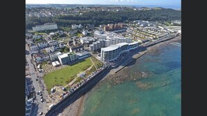 An aerial view of a coastal town with modern buildings, a promenade, and clear waters. - Penthouse apartment with stunning sea view Westward Ho! (Westward Ho!)