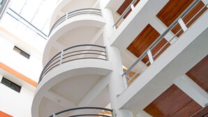 A multi-level interior with a spiral staircase, white walls, and wooden accents. - Hotel RC Tonsupa (Tonsupa)