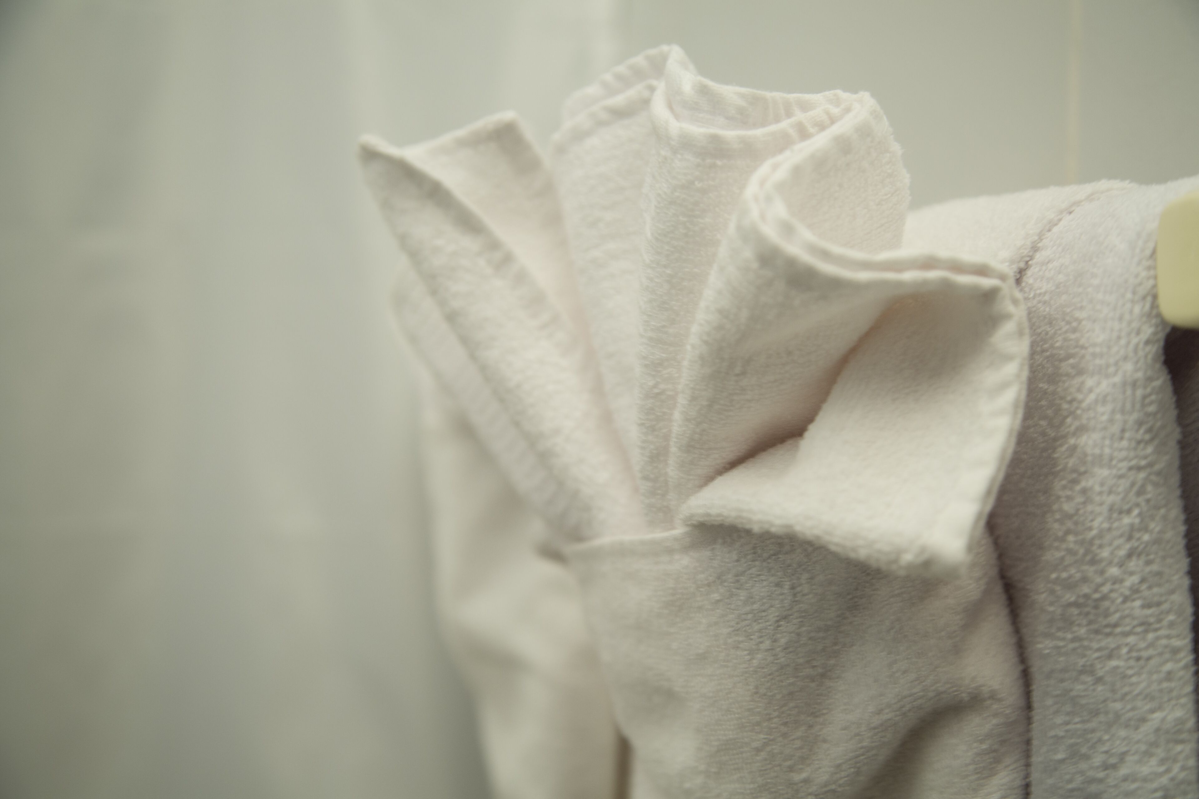A white towel hanging on a rack.