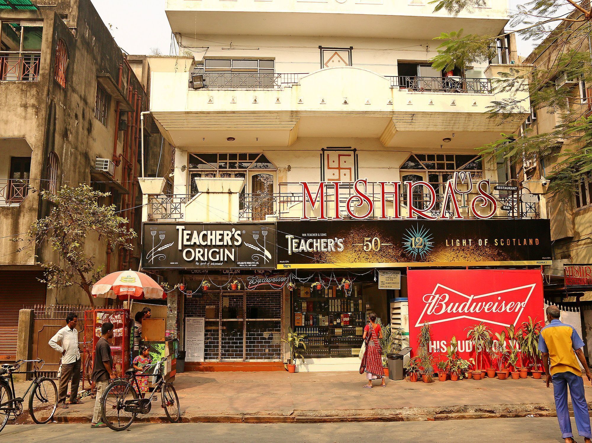 A building with a sign for 'Mishkas' and 'Teacher's Origin' on the ground floor.