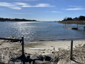 Enjoy a serene lakeside retreat with a clear view of the water and a sandy beach area.