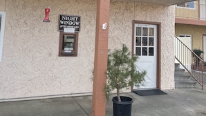 A building with a 'Night Window' sign, a small tree in a planter, and a '333 S Main St.' address. - CRYSTAL MOTEL (Red Bluff)