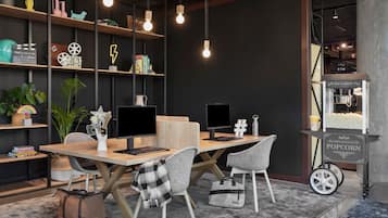 A modern workspace with desks, chairs, and a popcorn cart.