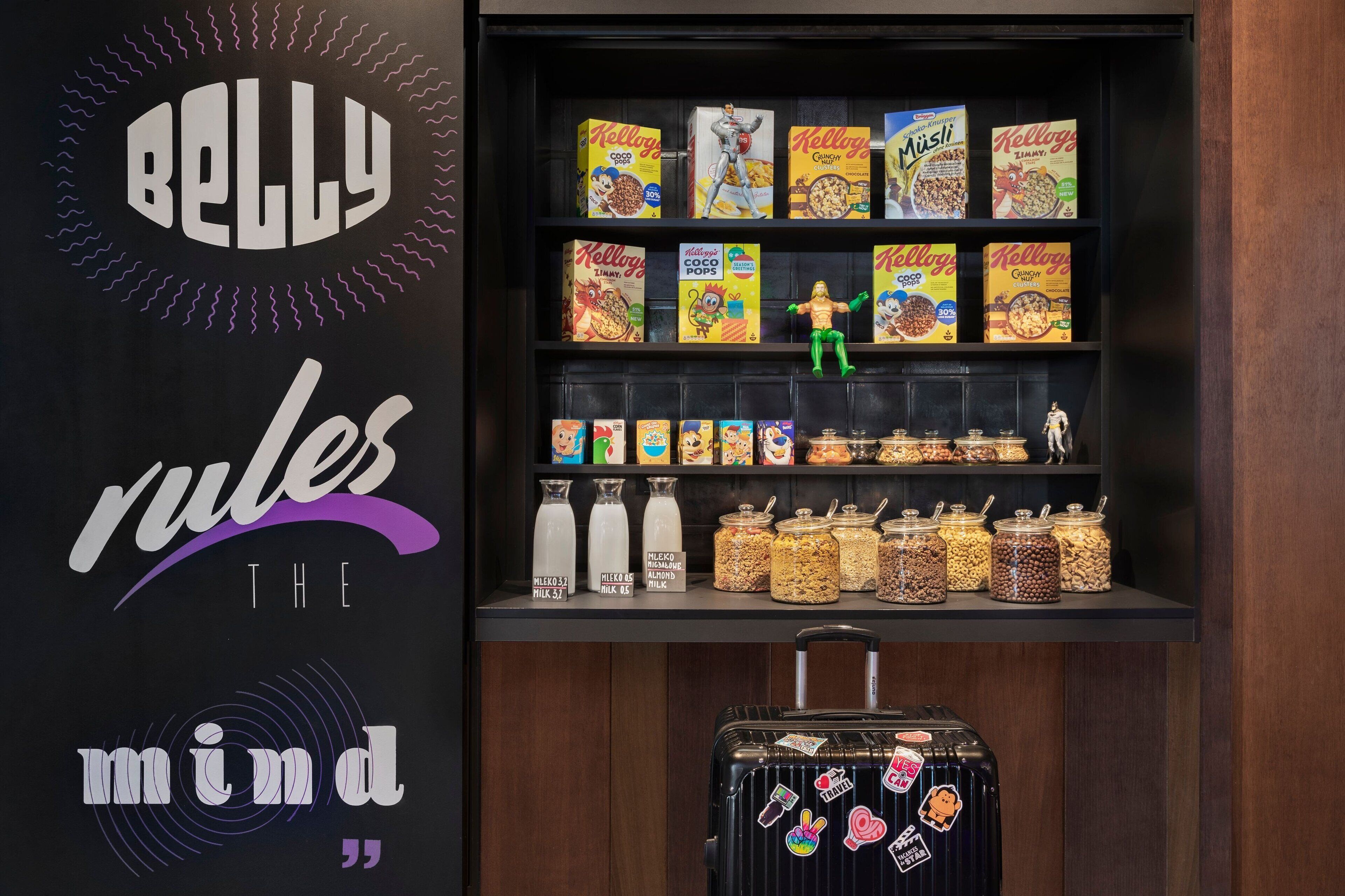 A shelf with various cereal boxes and jars of nuts and dried fruits.