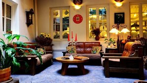 A cozy living room with a sofa, armchairs, a coffee table, and a fireplace. - Centro Kubas - Angel (Vilnius)
