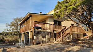 A two-story house with a balcony, a staircase, and a patio area. - Frio Honeymoon - Best view in Concan (Concan)