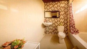A bathroom with a toilet, sink, and bathtub.