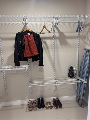 A closet with shelves for hanging clothes and shoes. - Sea Salt escape/ Beachfront apartment (Portmore)