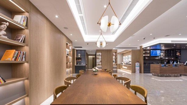 A modern interior with a long wooden table, chairs, bookshelves, and a central chandelier. - Hanting Shanghai Lujiazui Oriental Pearl (Shanghai)