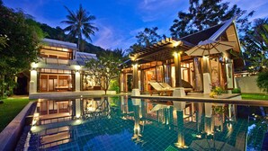 A modern resort with a large swimming pool, two guest buildings, and lush tropical surroundings. - TED Villas (Koh Samui)