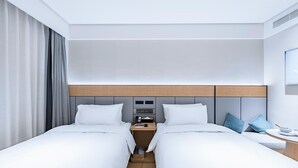 A modern hotel room with a large bed, a bedside table, a TV, and a window with curtains. - JI Hotel (Shanghai)