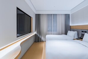 A hotel room with two beds, a large window, a curtain, and a wooden headboard. - JI Hotel (Shanghai)