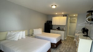 A hotel room with two beds, a kitchenette, and a small bathroom. - Rio Motel and Suites (Wildwood)