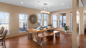 A spacious kitchen with a large wooden island, recessed ceiling lights, and large windows offering views of the outdoors. - Lake front with dock and boat ramp (Waverly)