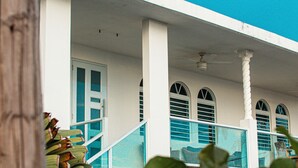 A white building with a blue sky, a staircase, and a door. - 4 Bedrooms,5 beds, 3 Full bathrooms,Sleeps up to 8 with private pool (rincon)