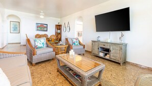 A spacious living room with wicker furniture, a flat-screen TV, and a wooden cabinet. - 4 Bedrooms,5 beds, 3 Full bathrooms,Sleeps up to 8 with private pool (rincon)
