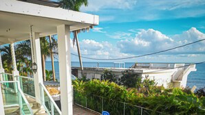 A swimming pool with a blue inflatable shark, surrounded by lounge chairs and a glass railing. - 4 Bedrooms,5 beds, 3 Full bathrooms,Sleeps up to 8 with private pool (rincon)